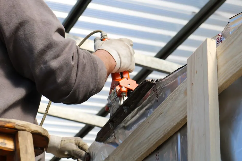 A construction worker using a power tool on a building project in Treviso, Italy.